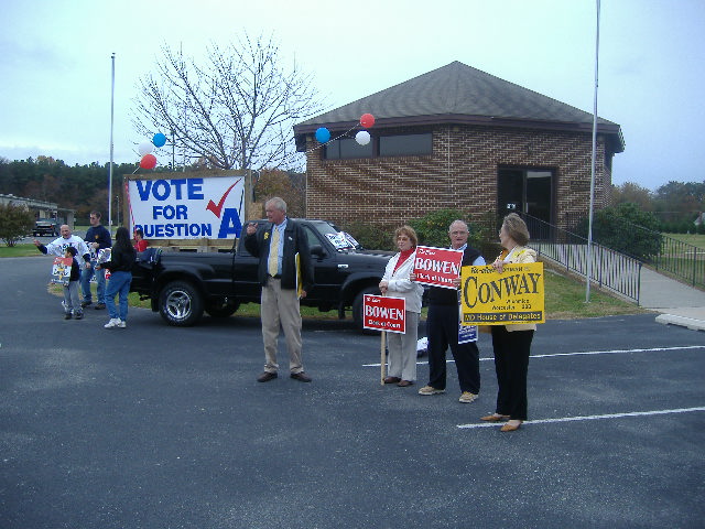 Kirk Daugherty with his supporters, including one in an infamous yellow jacket.